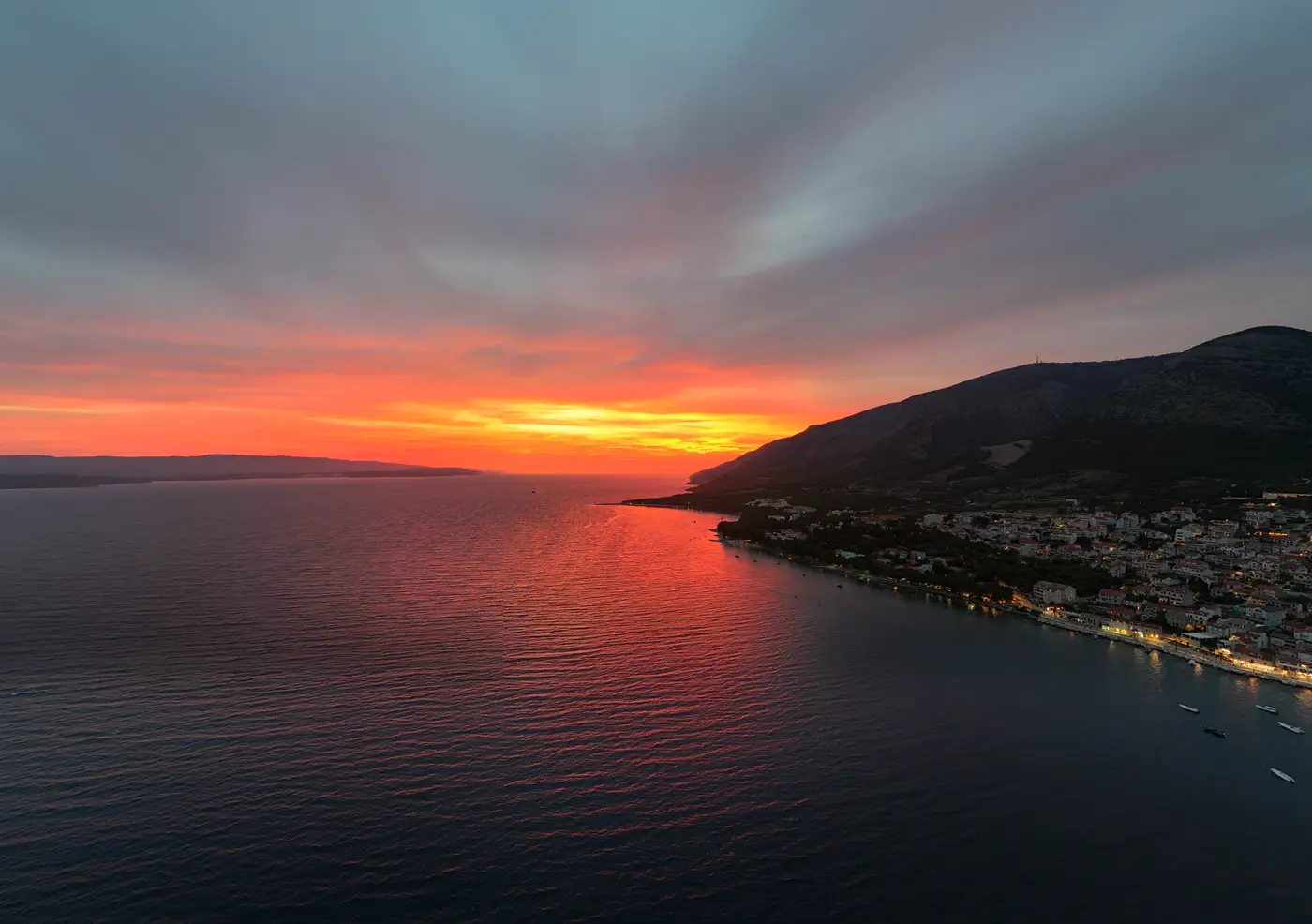 Aerial view of Bol under a fiery sunset sky