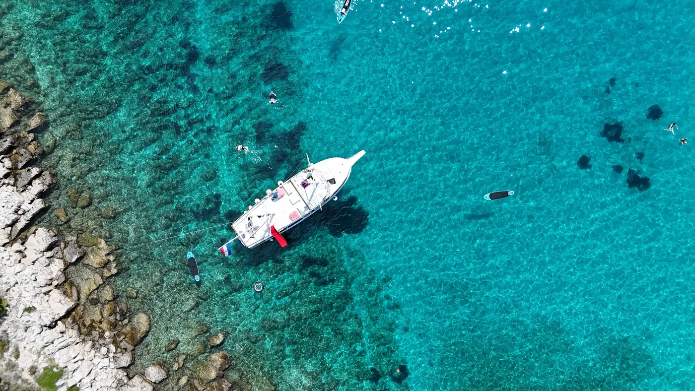 Aerial view of the boat over clear shallows