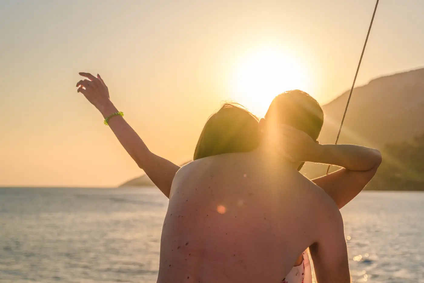 Couple embracing at sunset on the boat