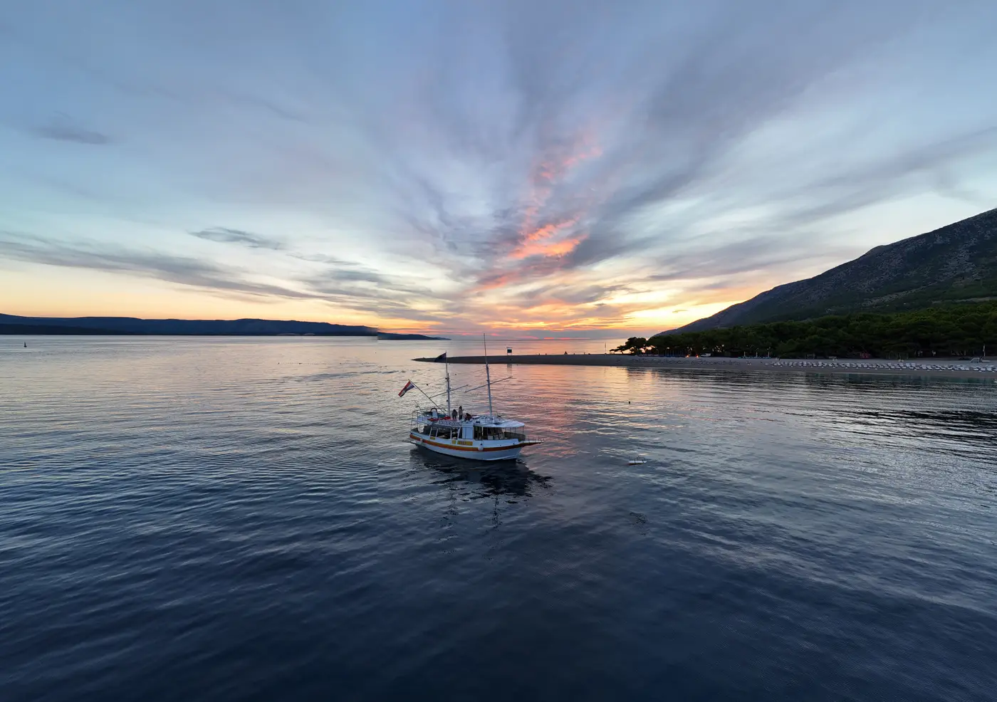 The excursion boat off Zlatni Rat at sunset