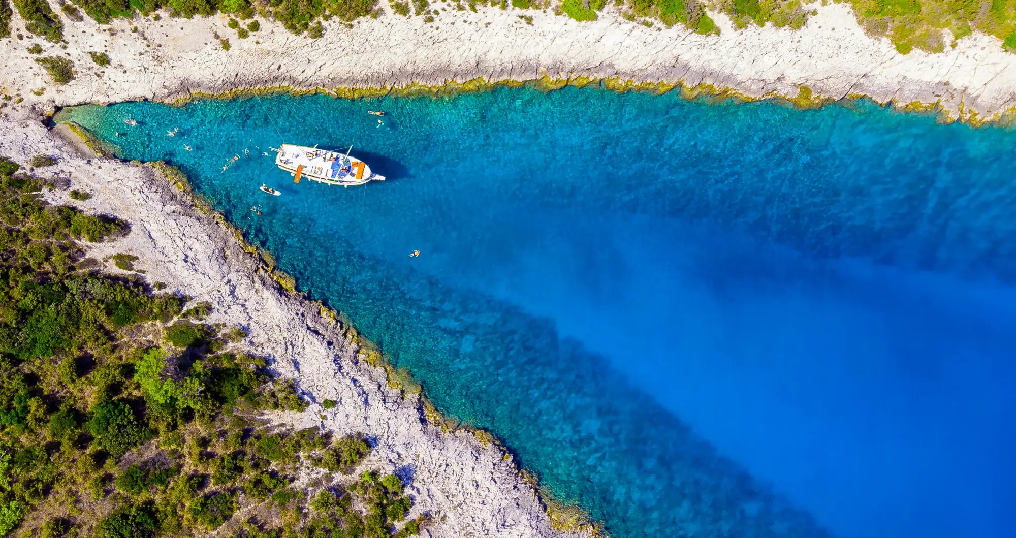 Veli Bol boat in a hidden Adriatic bay, aerial view