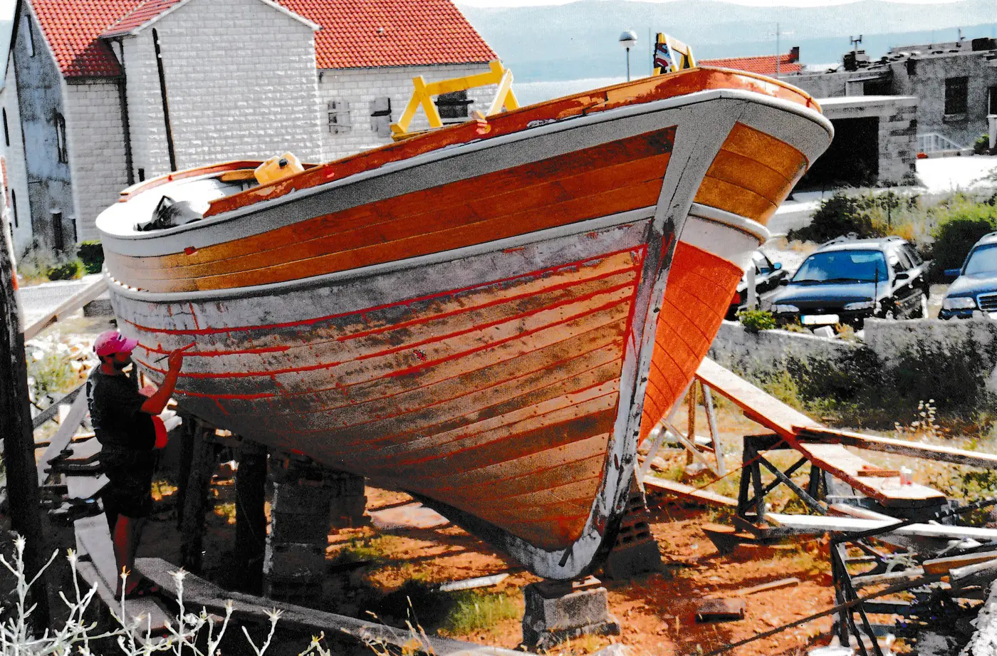 Painting the finished wooden hull by hand