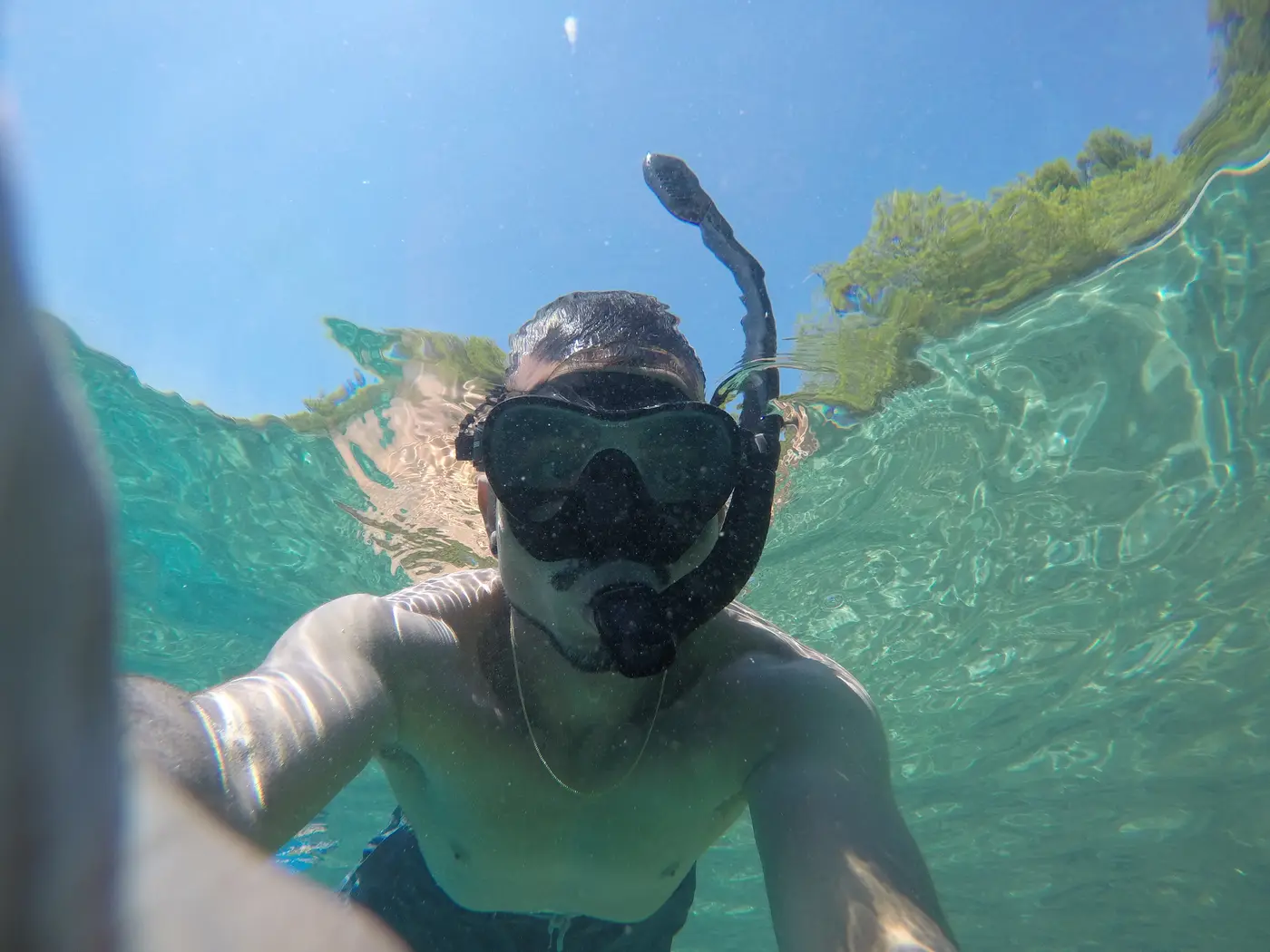 Snorkeler taking a selfie underwater